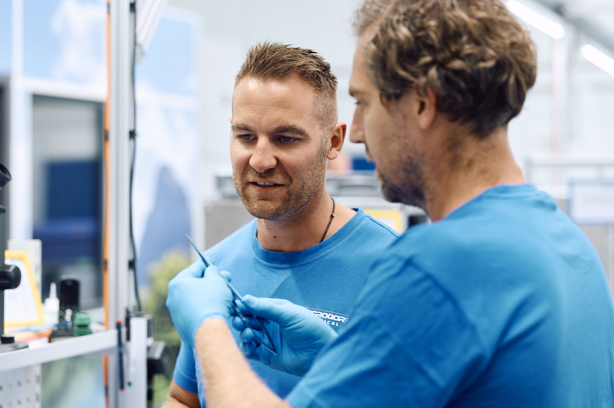 Colleagues inspecting a surgical instrument